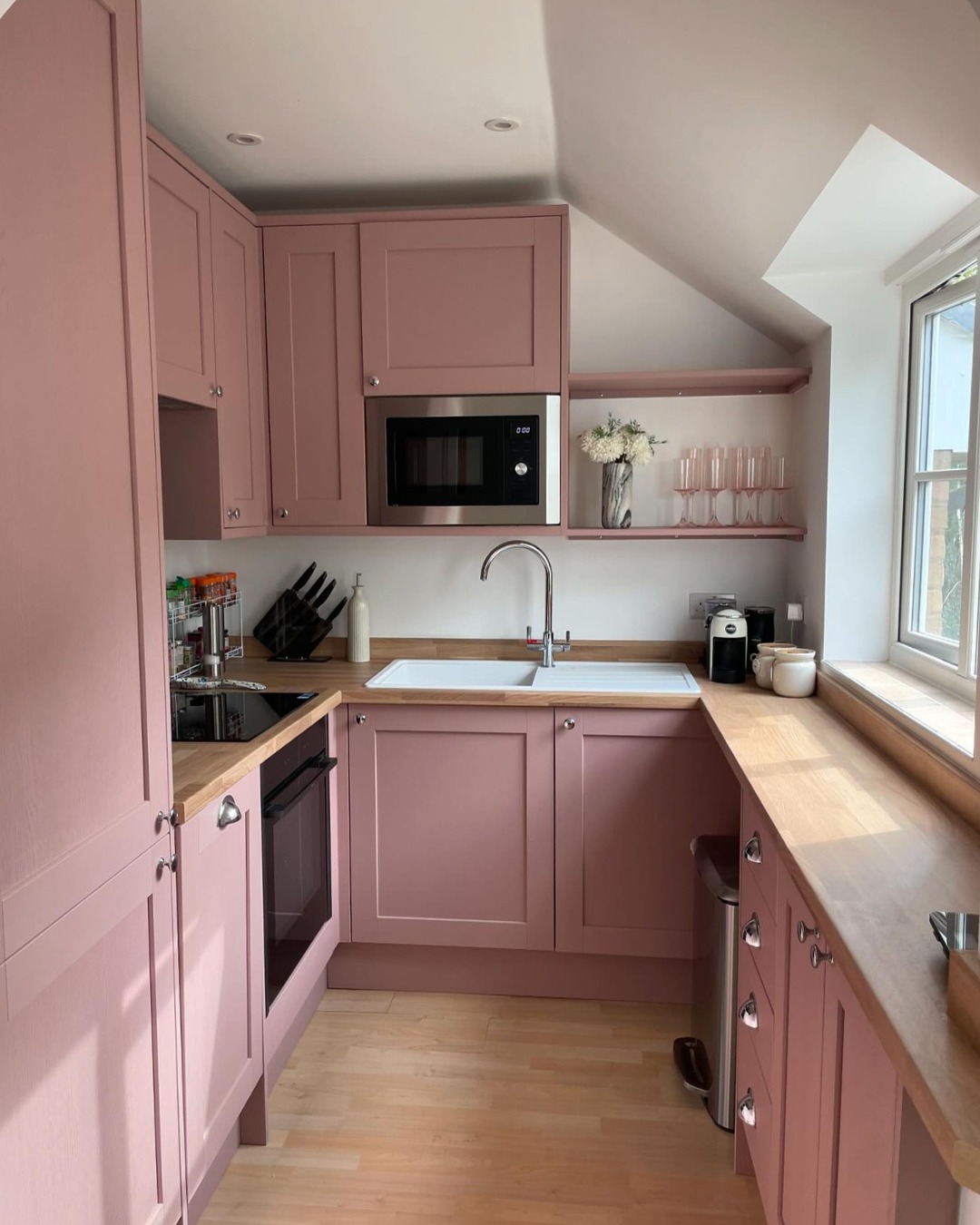 10. Vibrant Magenta Cabinets with Gold Accents and Geometric Backsplash