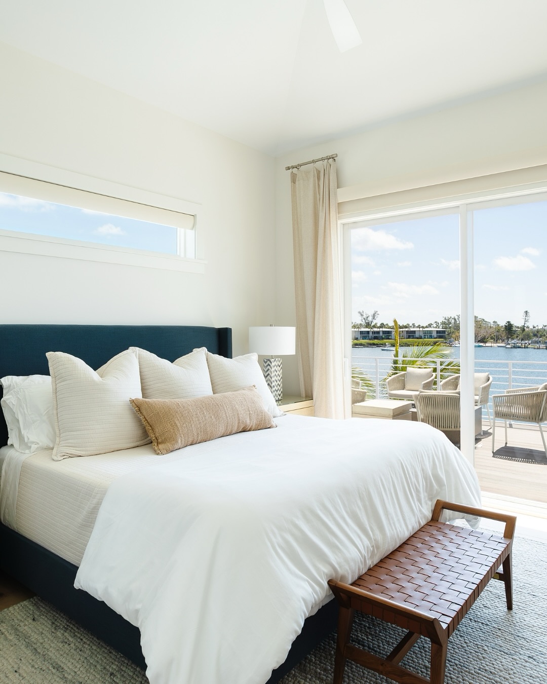 15. Coastal Bedroom with a Nautical Hammock and Porthole Window Accent