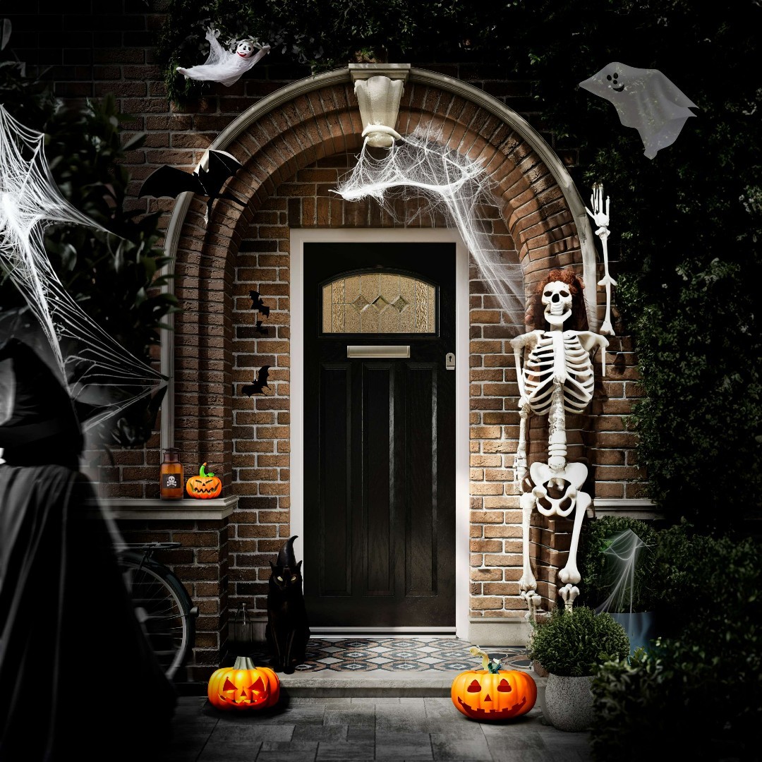 16. Spooky Spider Web Woven with Glowing Orange Pumpkins and Creepy Crawlies