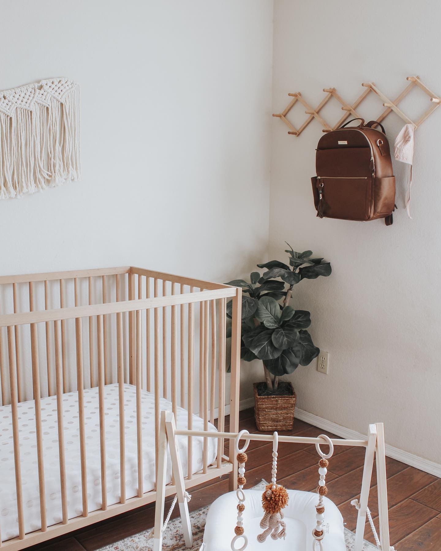 7. Crimson Geometric Mobile Above Crib In Sunlit Corner Of White-walled Nursery