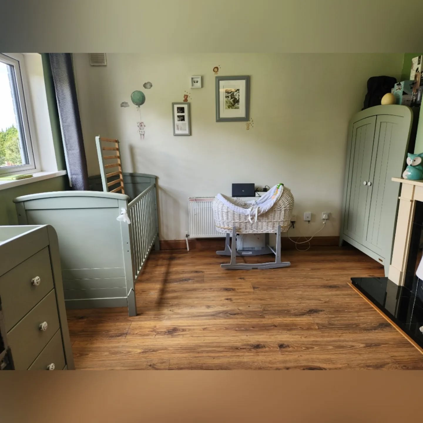 38. Sage Green Canopy Cradling a Vintage Crib with Whimsical Wallpaper