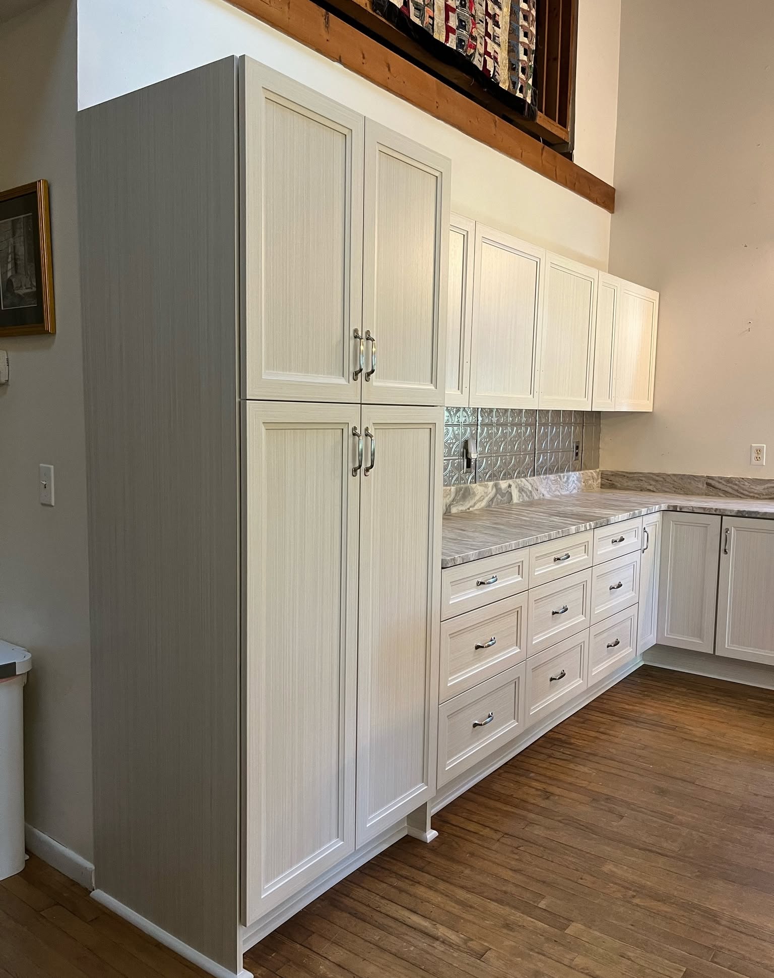 29. White Kitchen Cabinets with Brass Hardware and Geometric Backsplash Mosaic