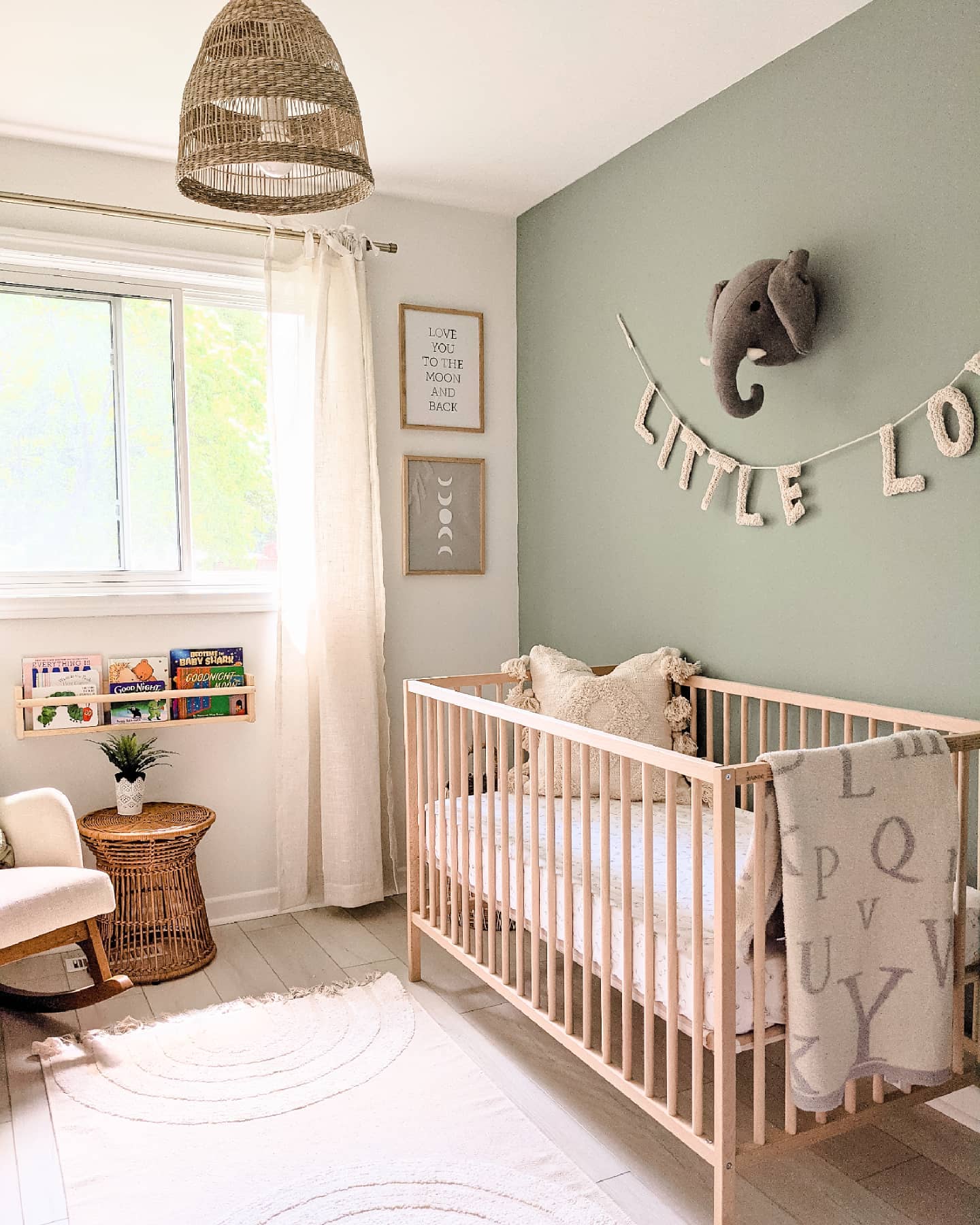 12. Sage Green Crib with Origami Mobile and Geometric Wall Art In a Cozy Corner
