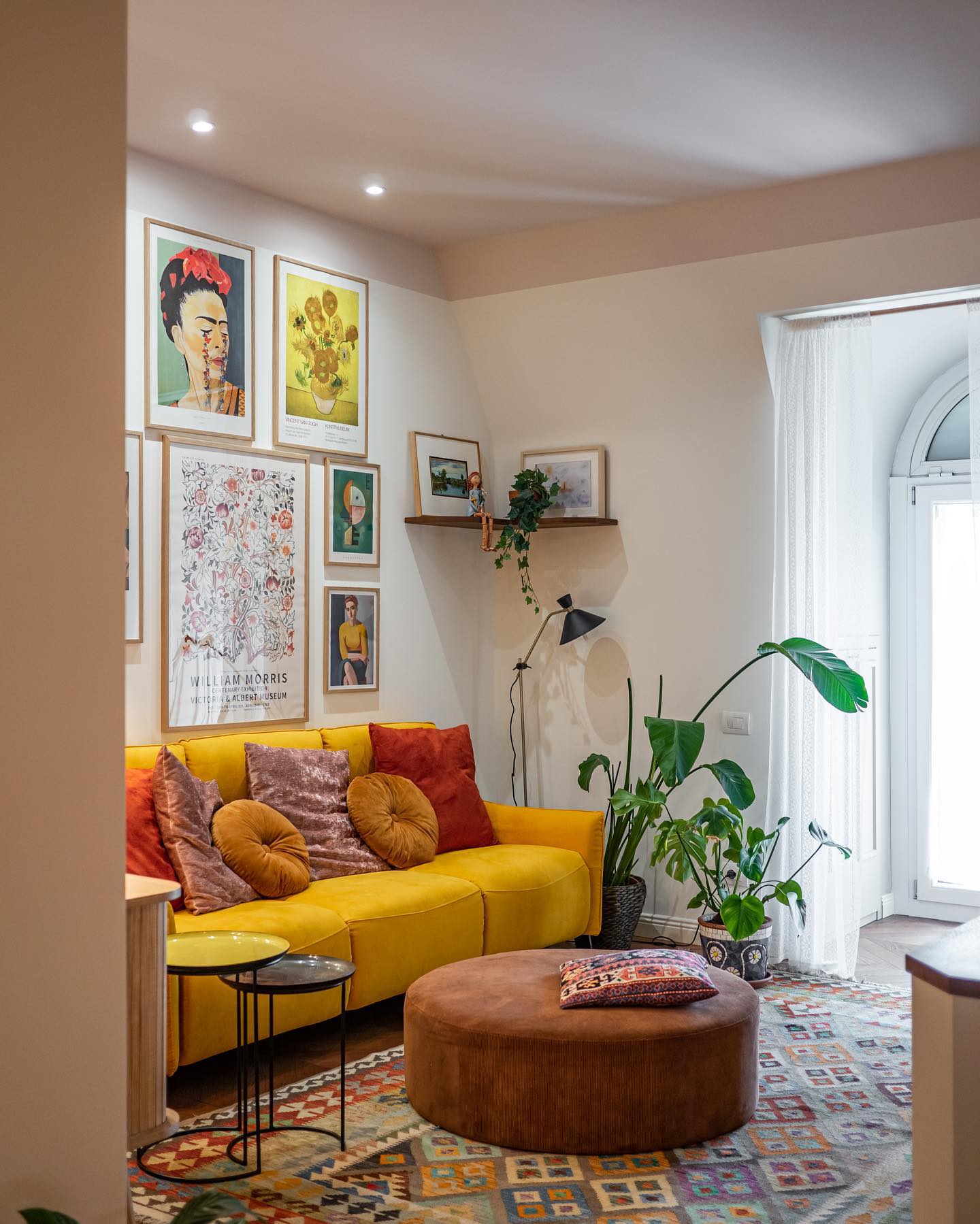 21. the Crimson Velvet Sofa with Geometric Wall Art In a Compact Space
