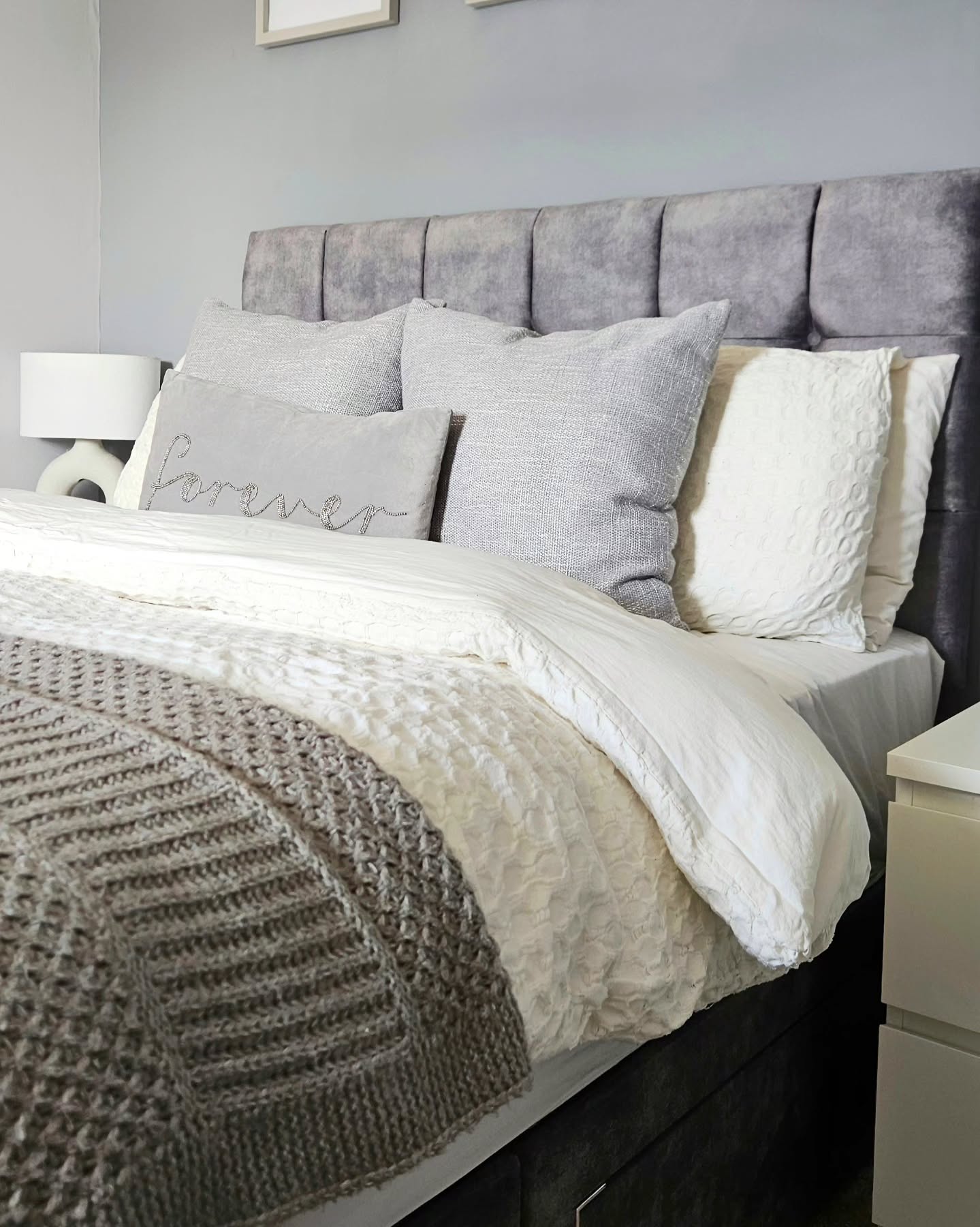 31. Silver Moonlight Escape: a Bedroom with Woven Wall Art and Distressed Wood Bed Frame