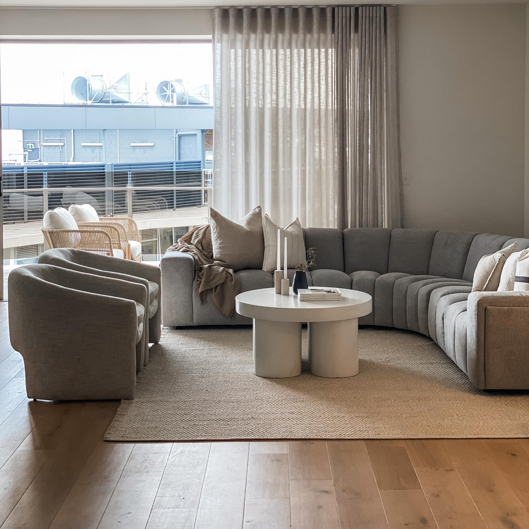 12. Moonlit Waves and Geometric Serenity: a Living Room with a Curved Sofa and Triangular Shelves