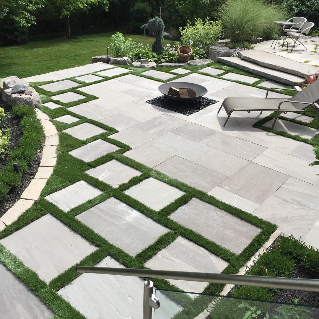 14. Whispers Of Moss and Stone: a Flagstone Patio Embraced by Nature's Quietude