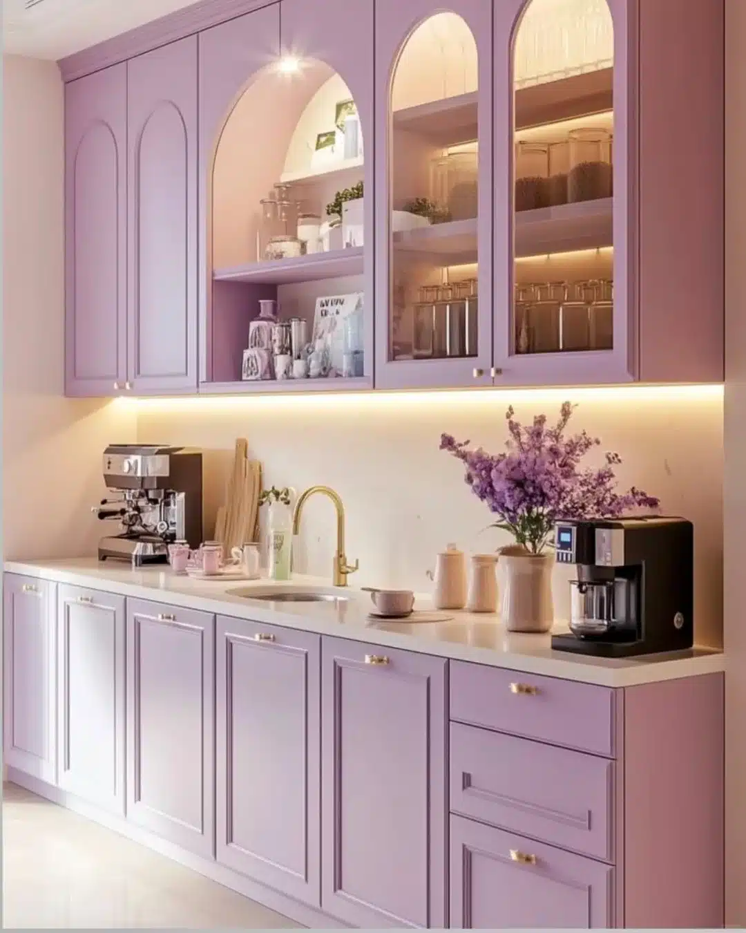 3. Vibrant Magenta Cabinets with Gold Accents and Geometric Tile Backsplash