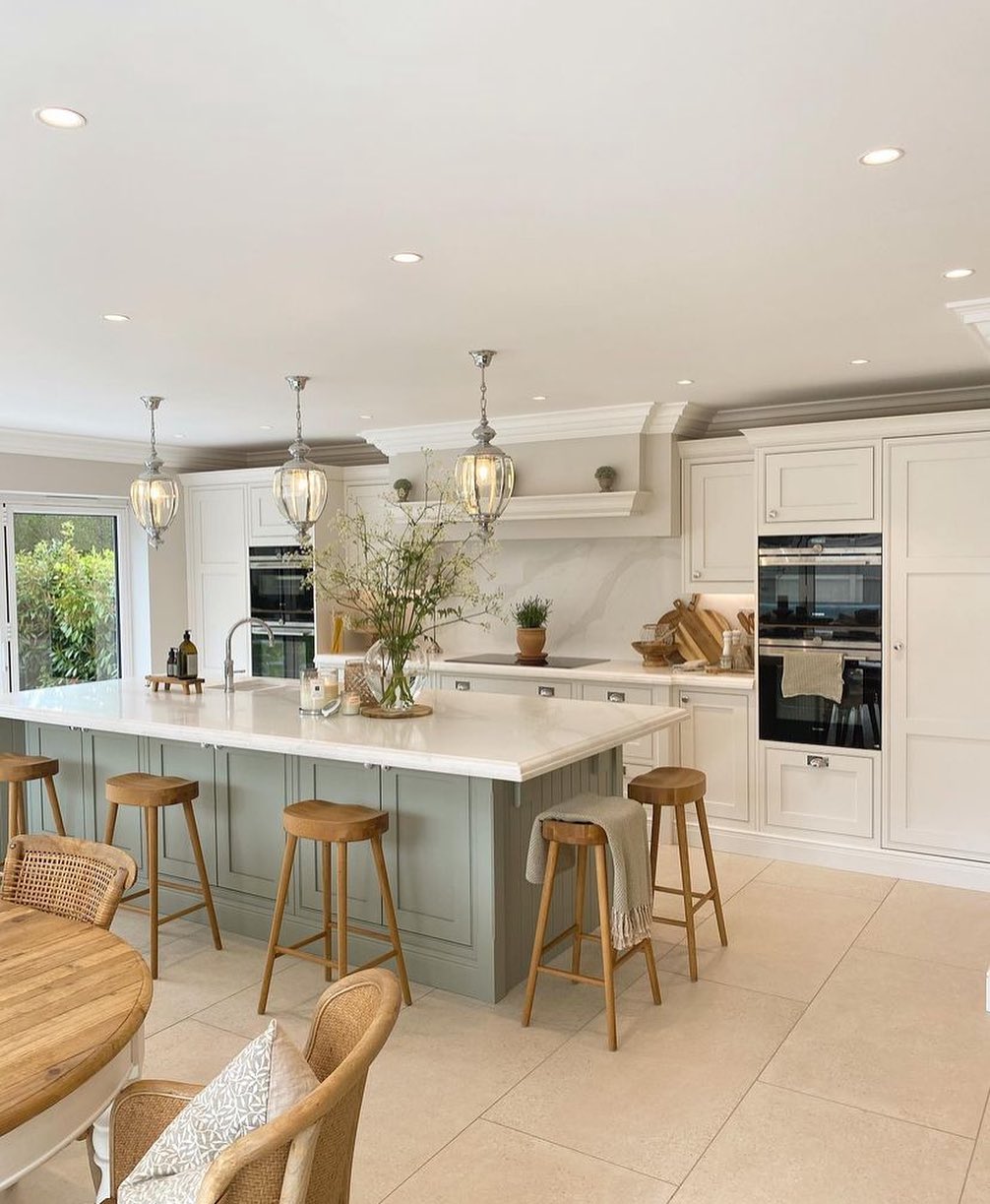 2. a Granite Monolith with a Waterfall Edge and Industrial Pendant Lights