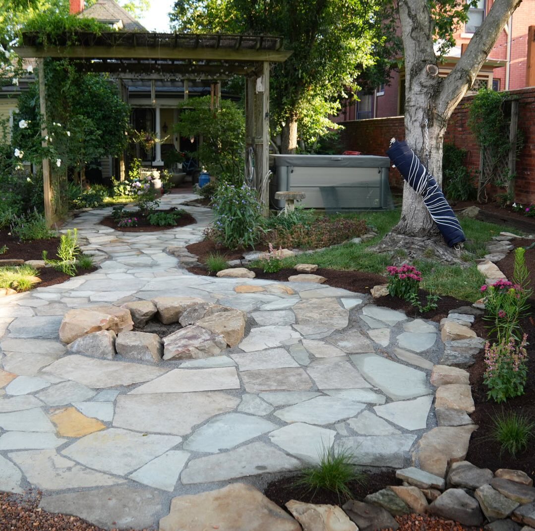 26. Cobblestone Accents and Circular Stone Bench In a Compact Garden Retreat