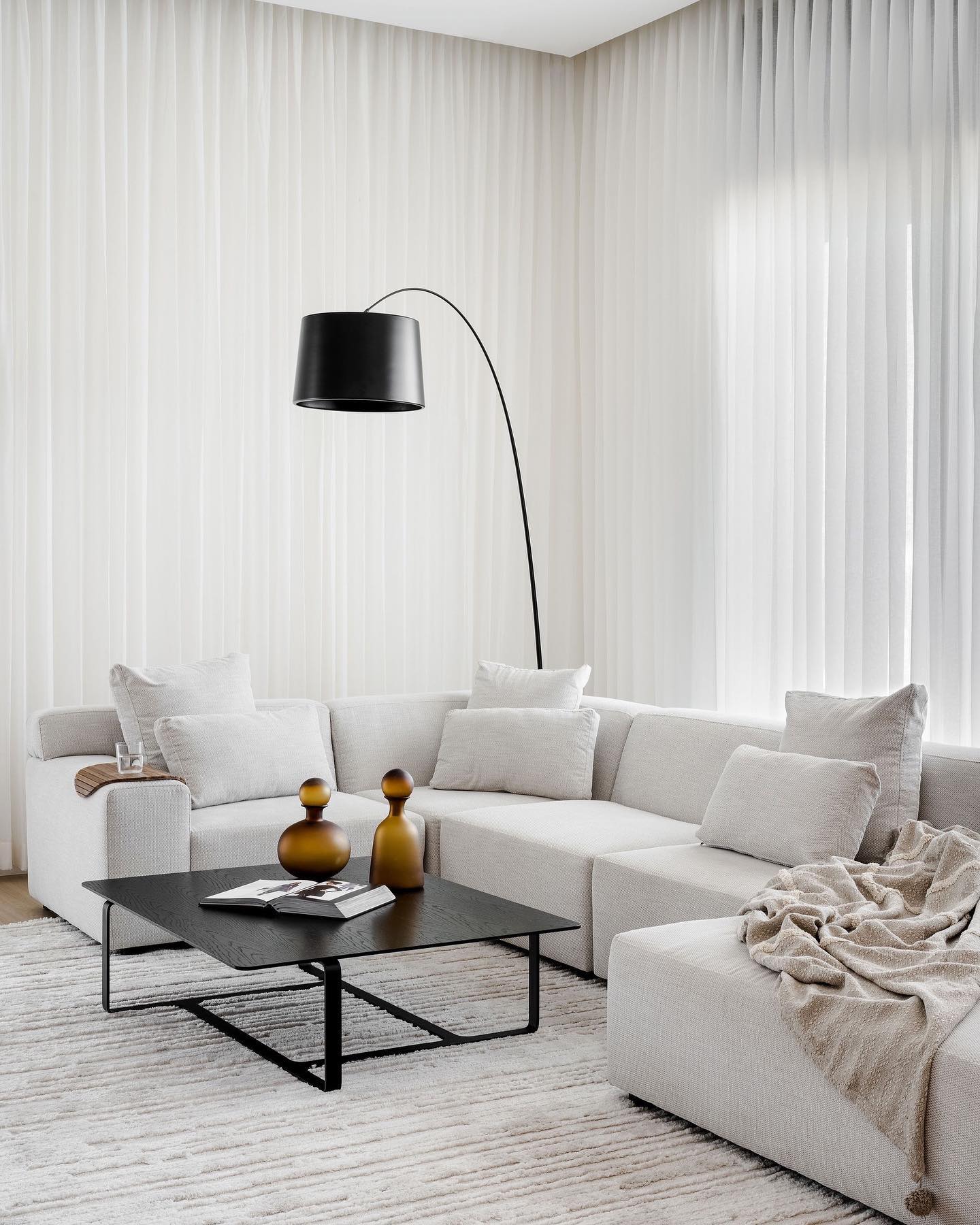 1. Soft Geometry In Monochrome: a Living Room with Angular White Shelves and Rounded Black Accents