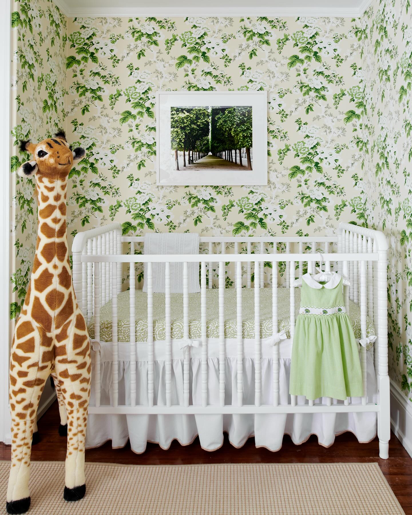 10. Sage Green Crib Amidst Geometric Wall Patterns and Monochrome Accents