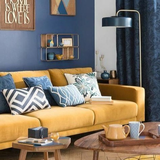 13. the Crimson Velvet Sofa and Geometric Gold Mirror Ensemble