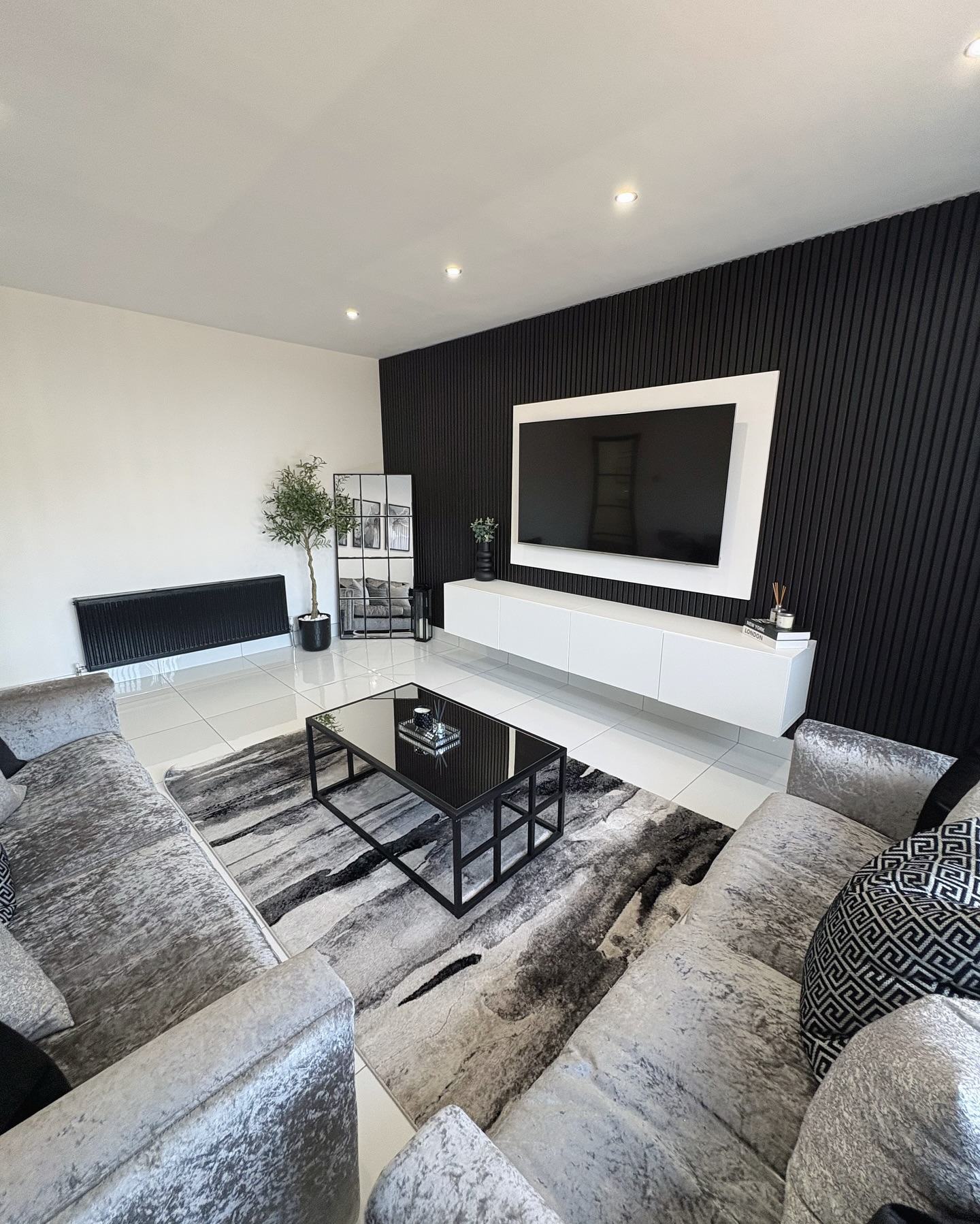 8. Neutral Living Room with a Floating Shelf Fireplace and Geometric Wall Art