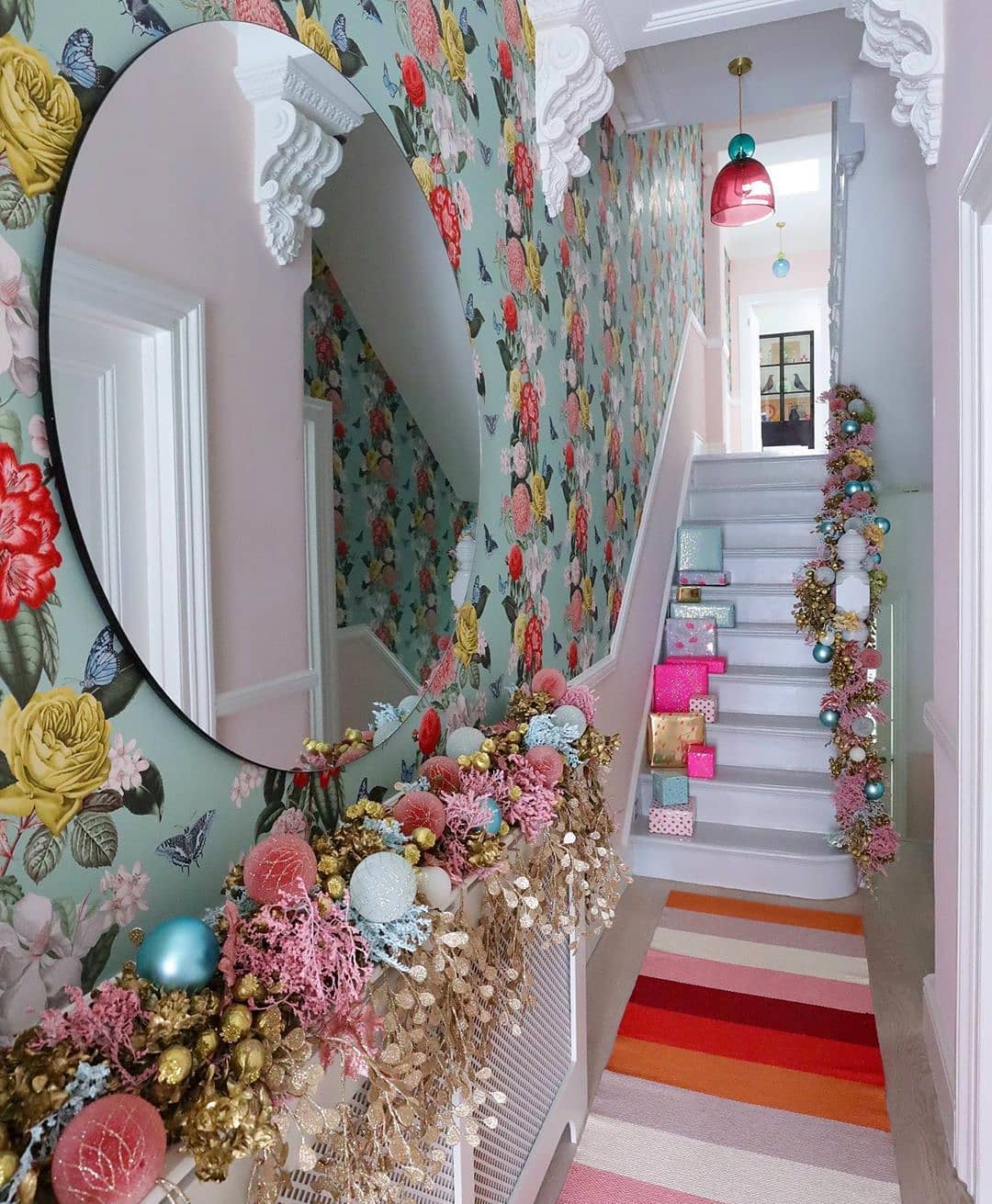 13. Crimson Ribbon Garland Twined with Pinecones and Silver Bells on a White Banister