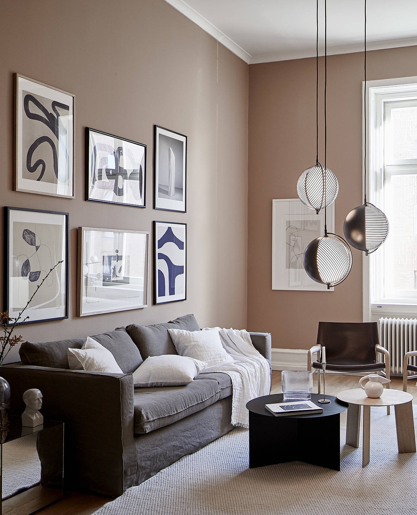 11. a Trio Of Vintage Frames Flanking a Central Modern Art Piece Above a Tufted Couch