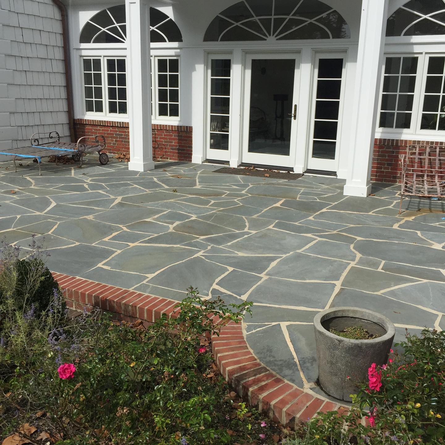 17. Flagstone Patio with a Sunken Fire Pit and Surrounding River Rock Mosaic