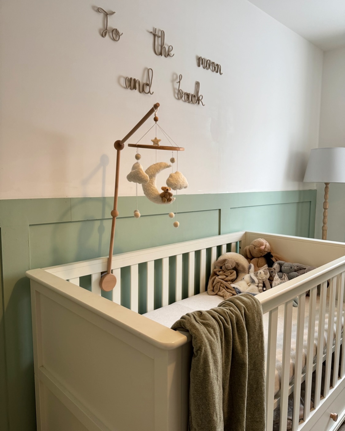 31. Soft Mossy Greens Meet Geometric Delight In This Crib Nook