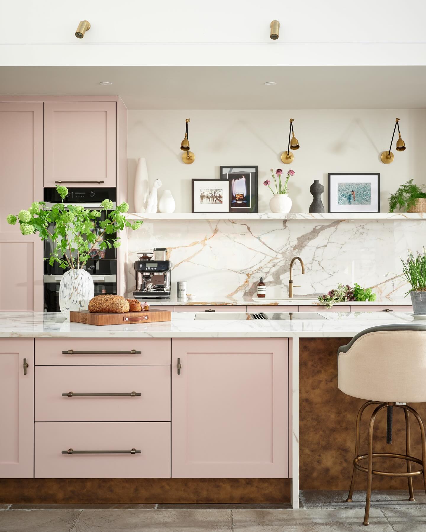 9. Vibrant Fuchsia Cabinets with Geometric White Tiles and a Sleek Black Range