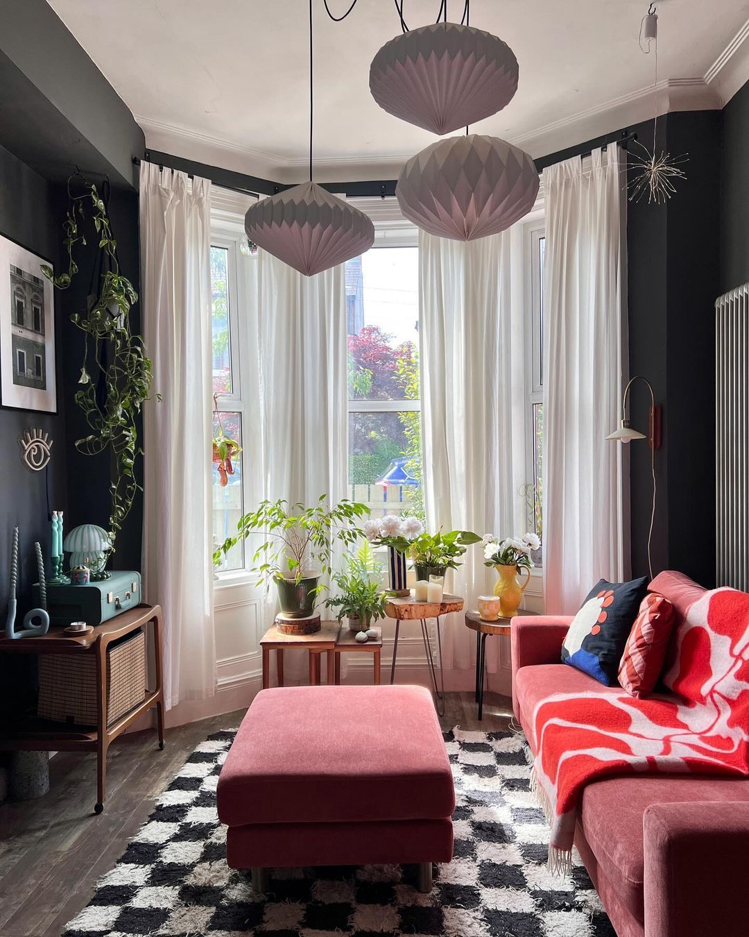 22. Cozy Nook with a Crimson Velvet Ottoman and Geometric Wall Art