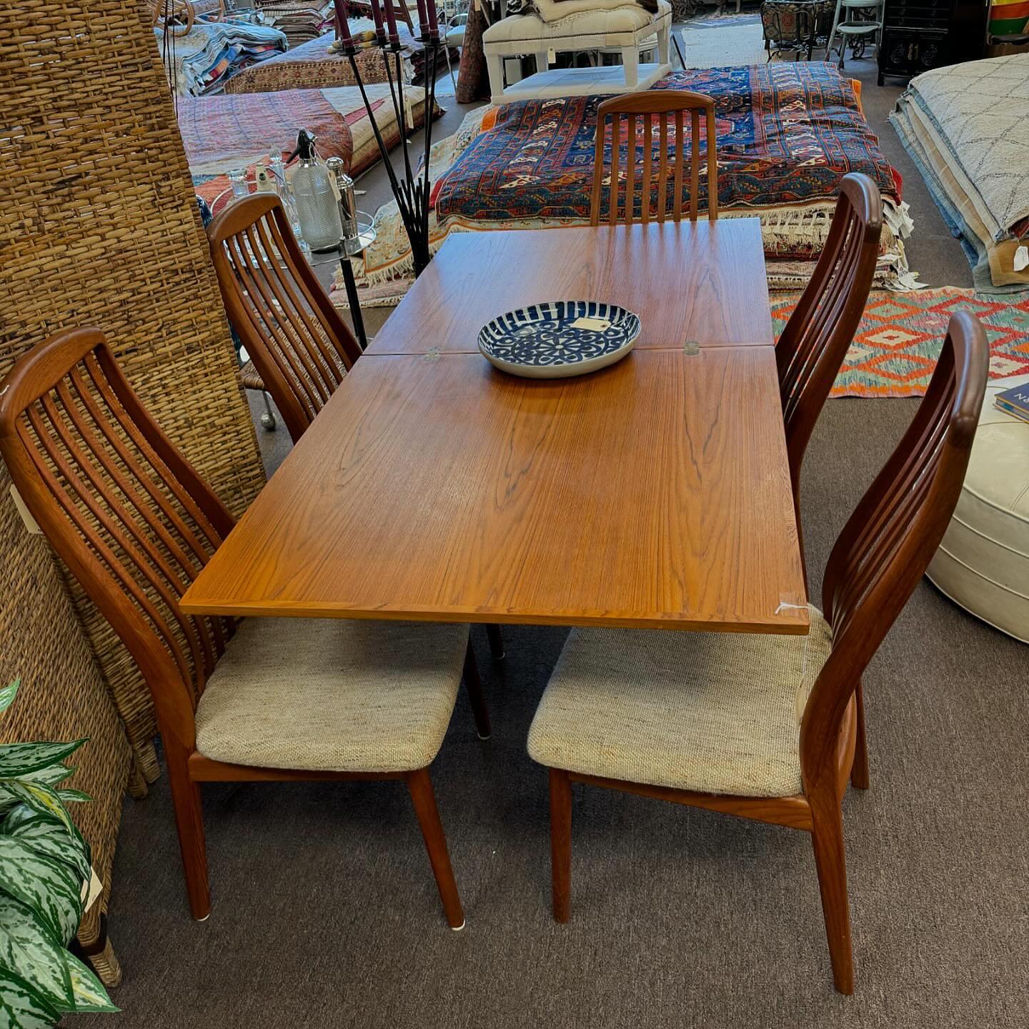 6. Mid-century Modern Dining Table with Hourglass Legs and Amber Glow
