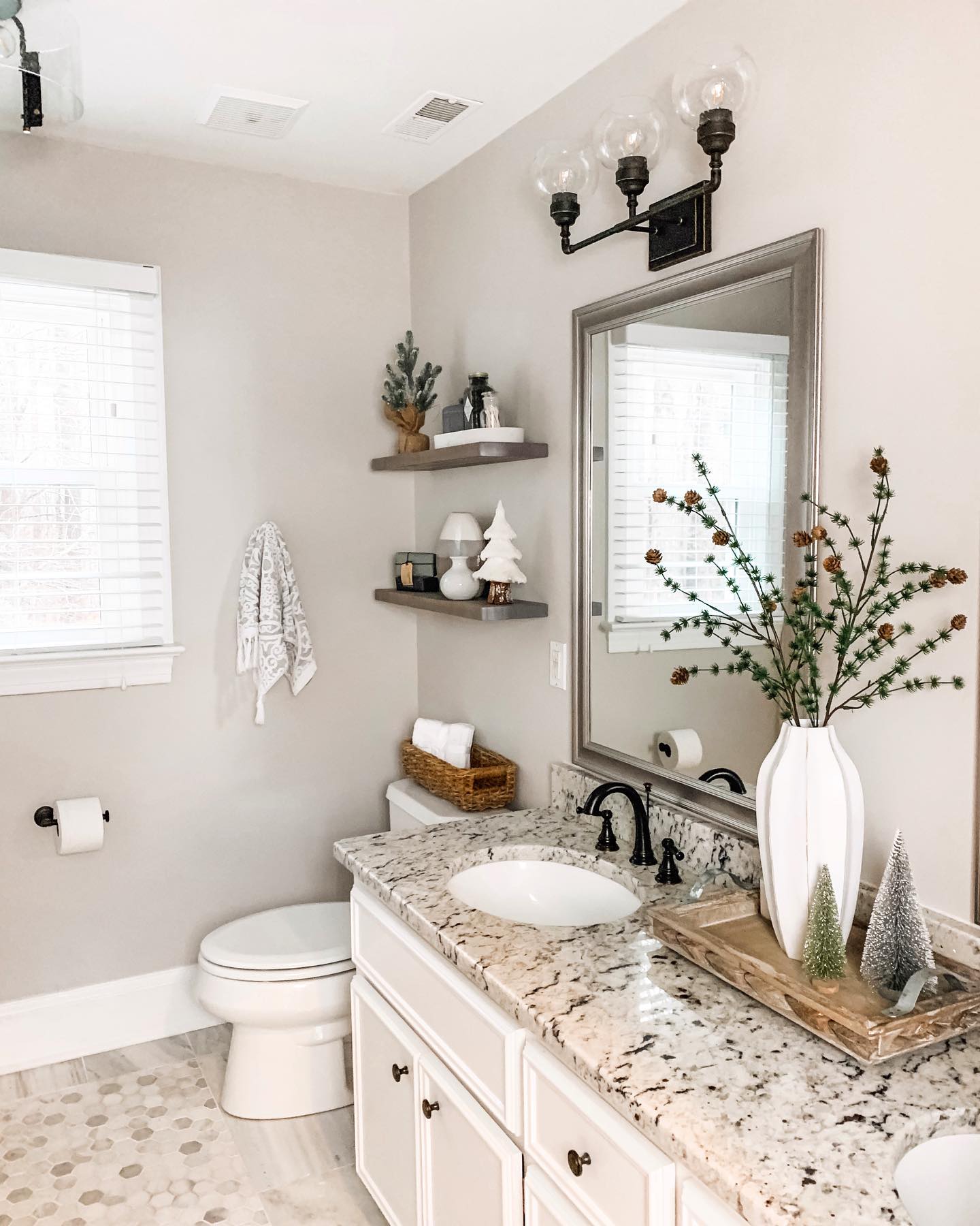 18. Festive Reindeer Towel Art with Candy Cane Accents on a Snowy White Vanity