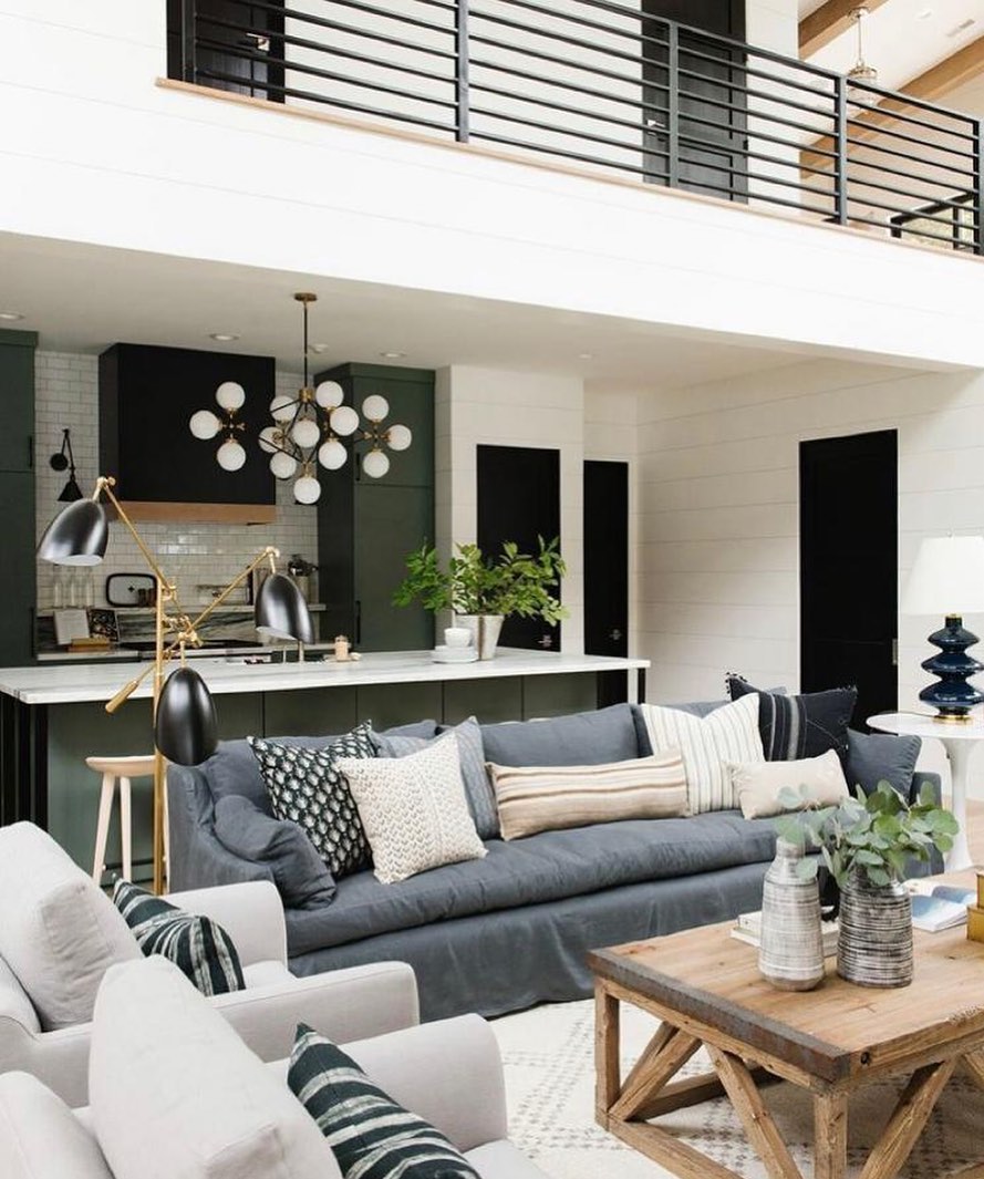 10. Velvet Armchair with Geometric Pillows Against a Monochrome Wall