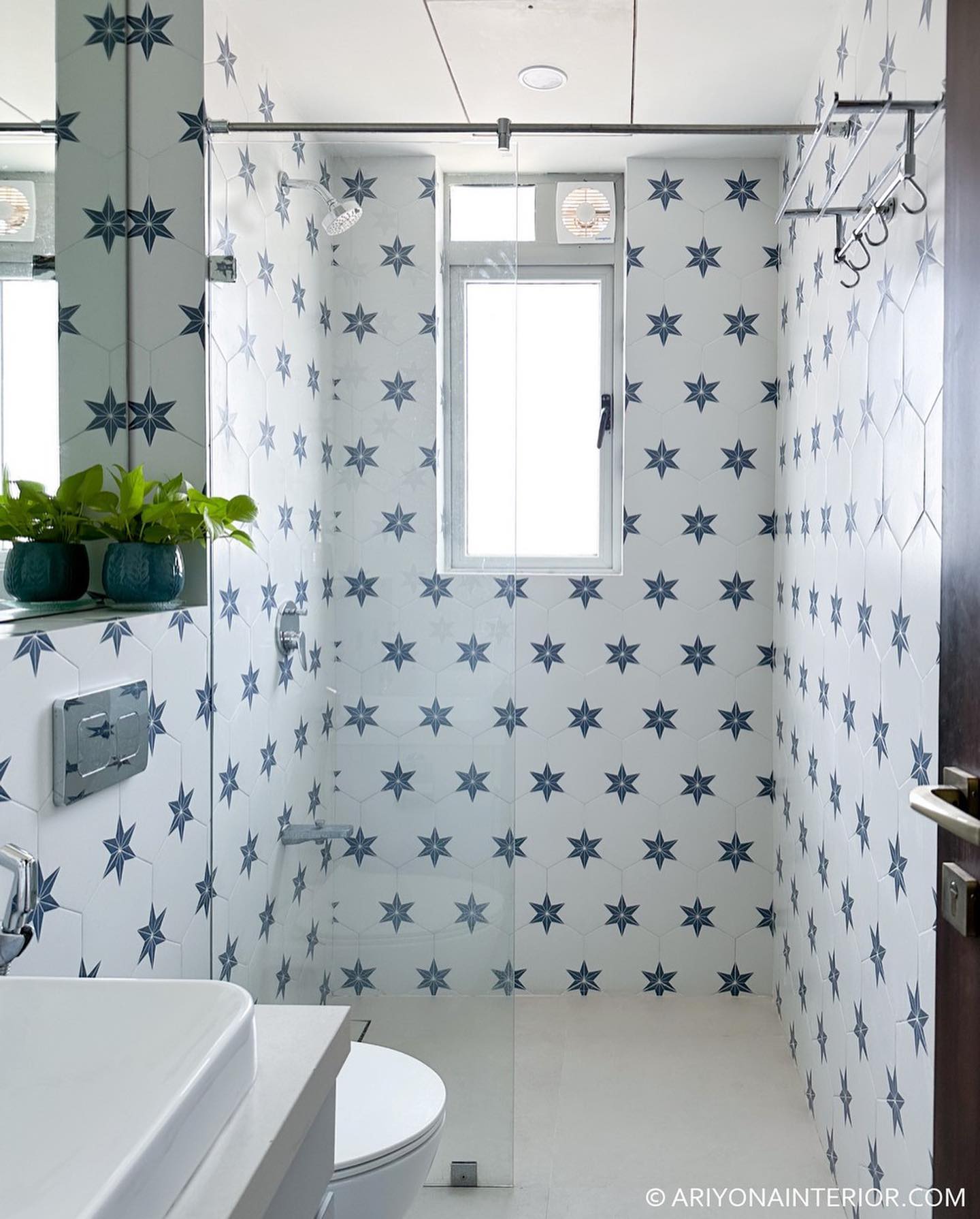 17. Moonlit Mosaic: a Black and White Bathroom with Hexagonal Floor Tiles and Oval Sink