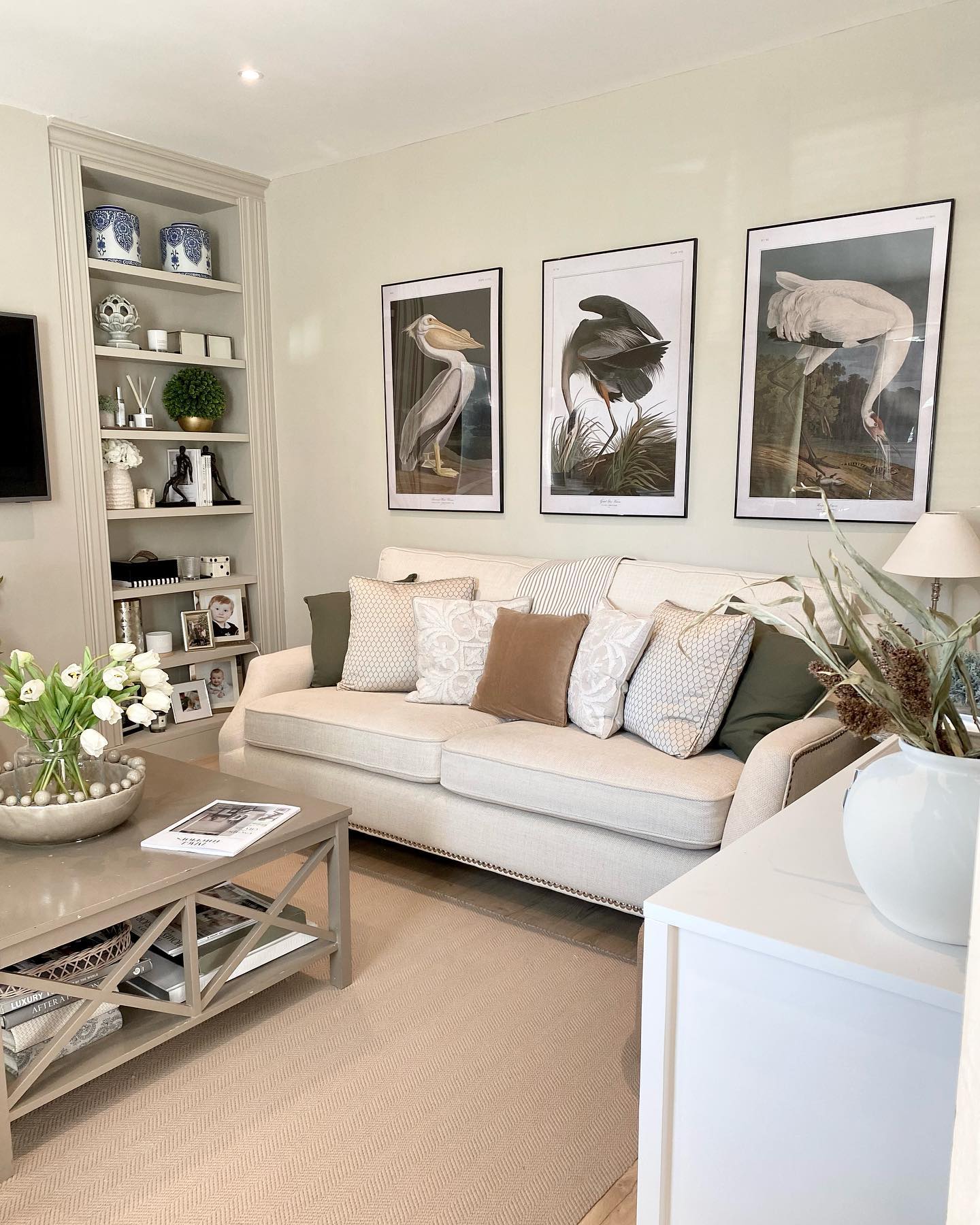 6. a Trio Of Vintage Cameras on a Wooden Shelf Above a Cream Couch