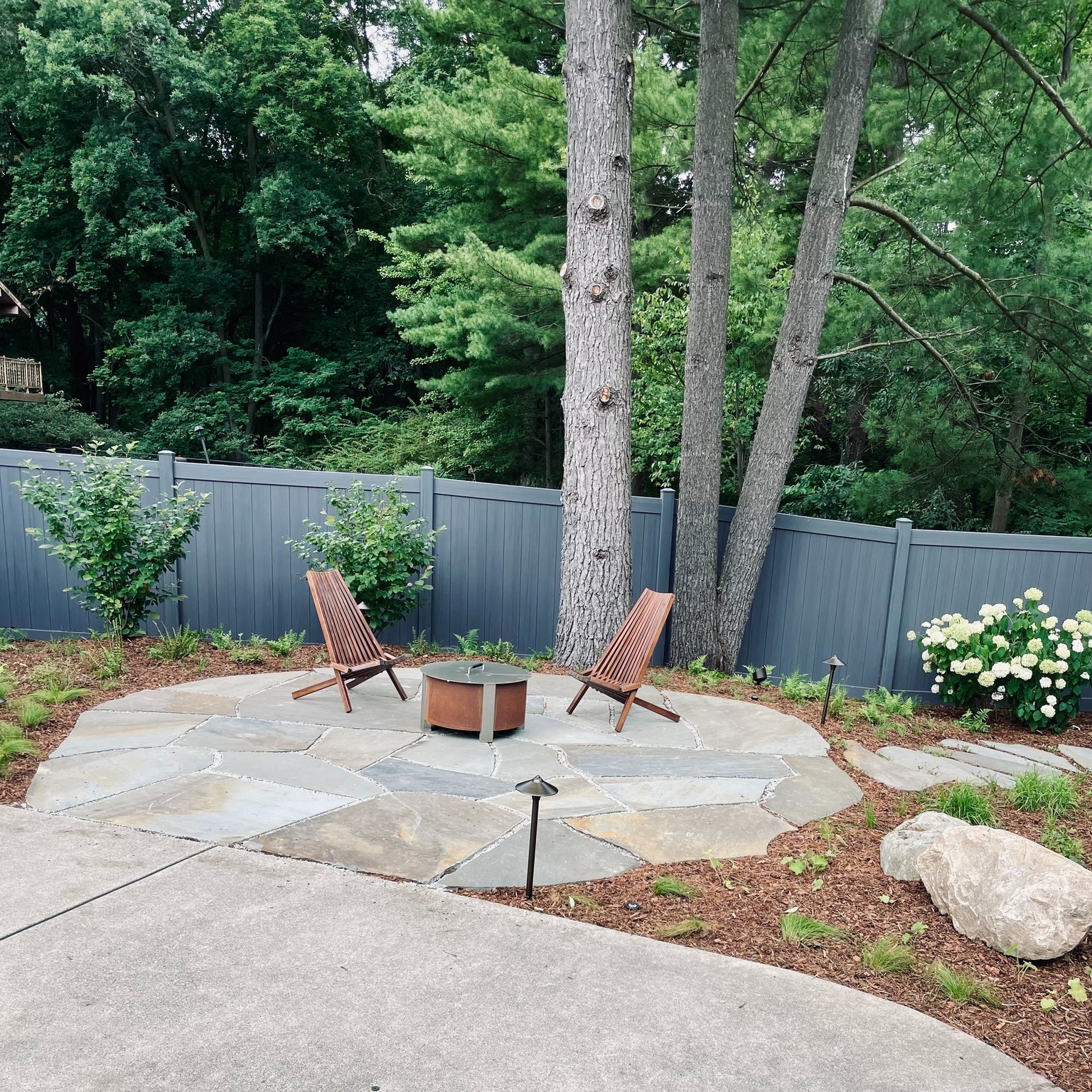 23. Sunlit Serenity: a Flagstone Patio with a Lone Cypress Accent