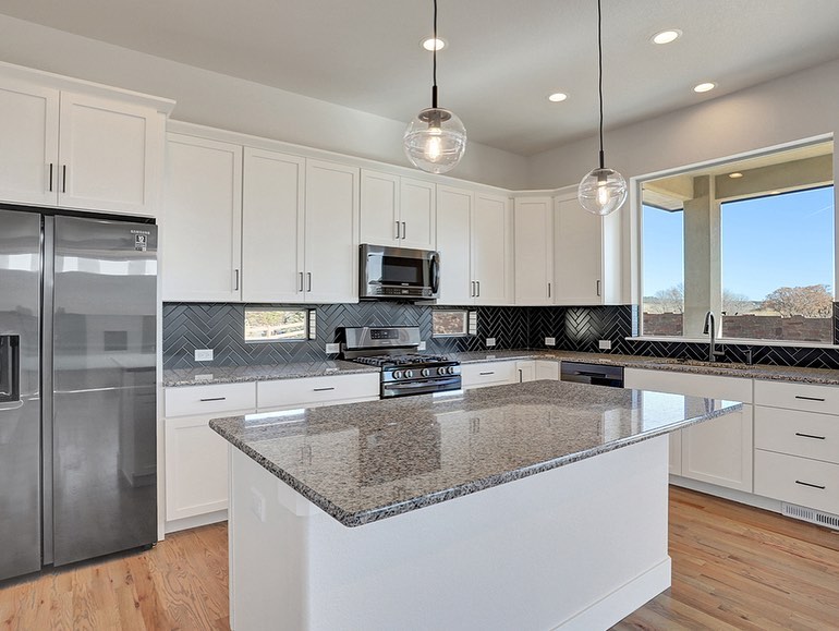30. Glossy Black Hexagons and Metallic Gold Accents: a Bold Backsplash Fusion