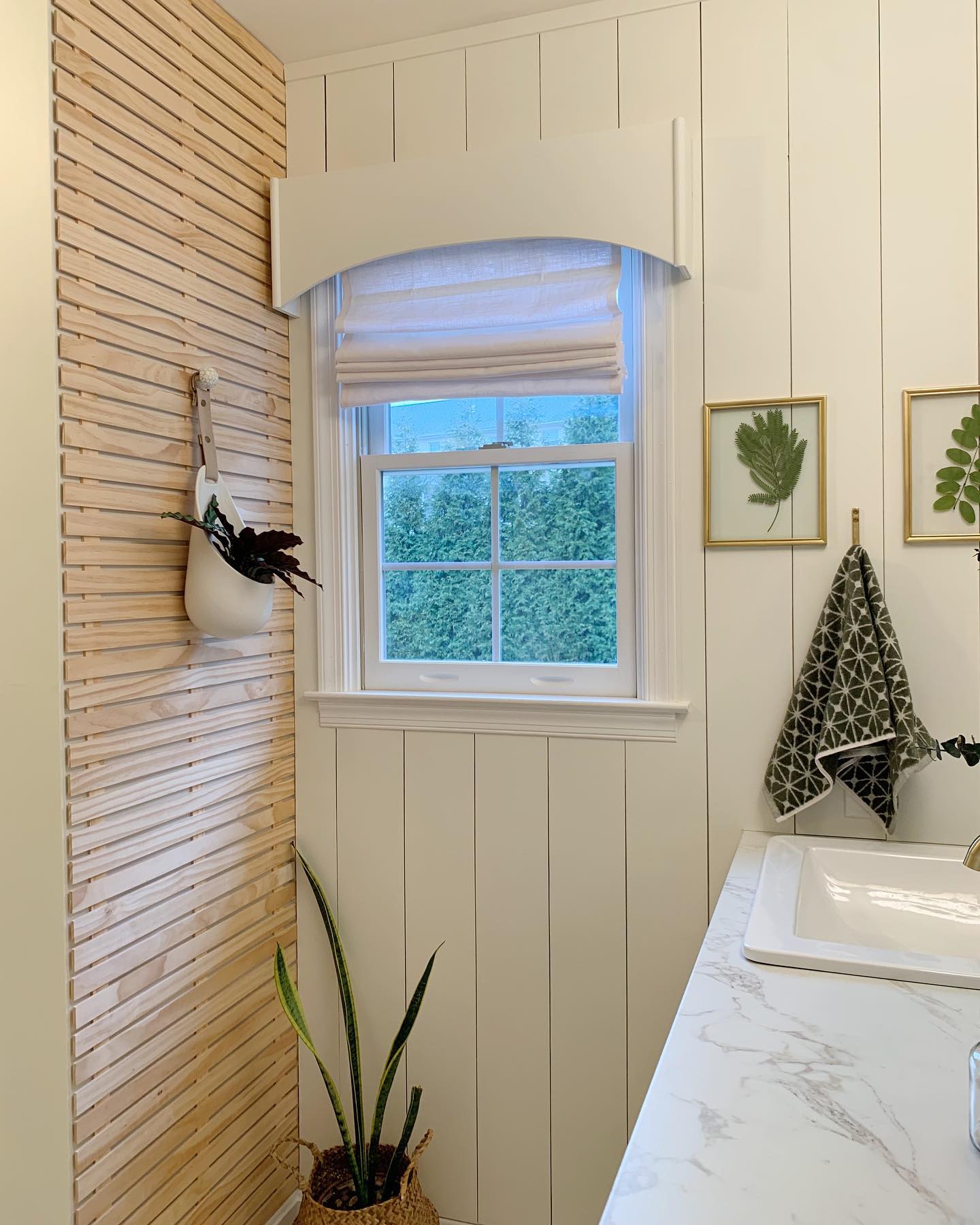 7. Shiplap Serenity: a Bath with a Botanical Twist and Brass Accents