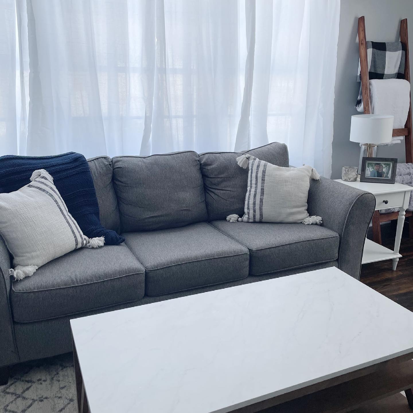 8. Cozy Nook with a Sunlit Geometric Quilt and Vintage Brass Lamp