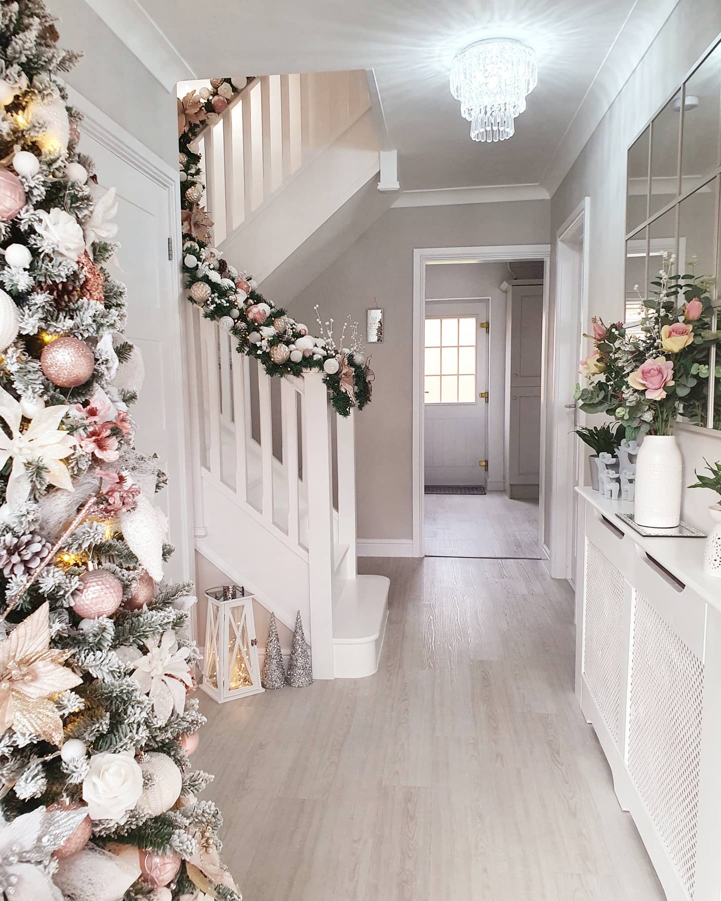 19. Festive Pinecones and Ribbons Adorn a Snowy Garland Over a Wooden Sleigh