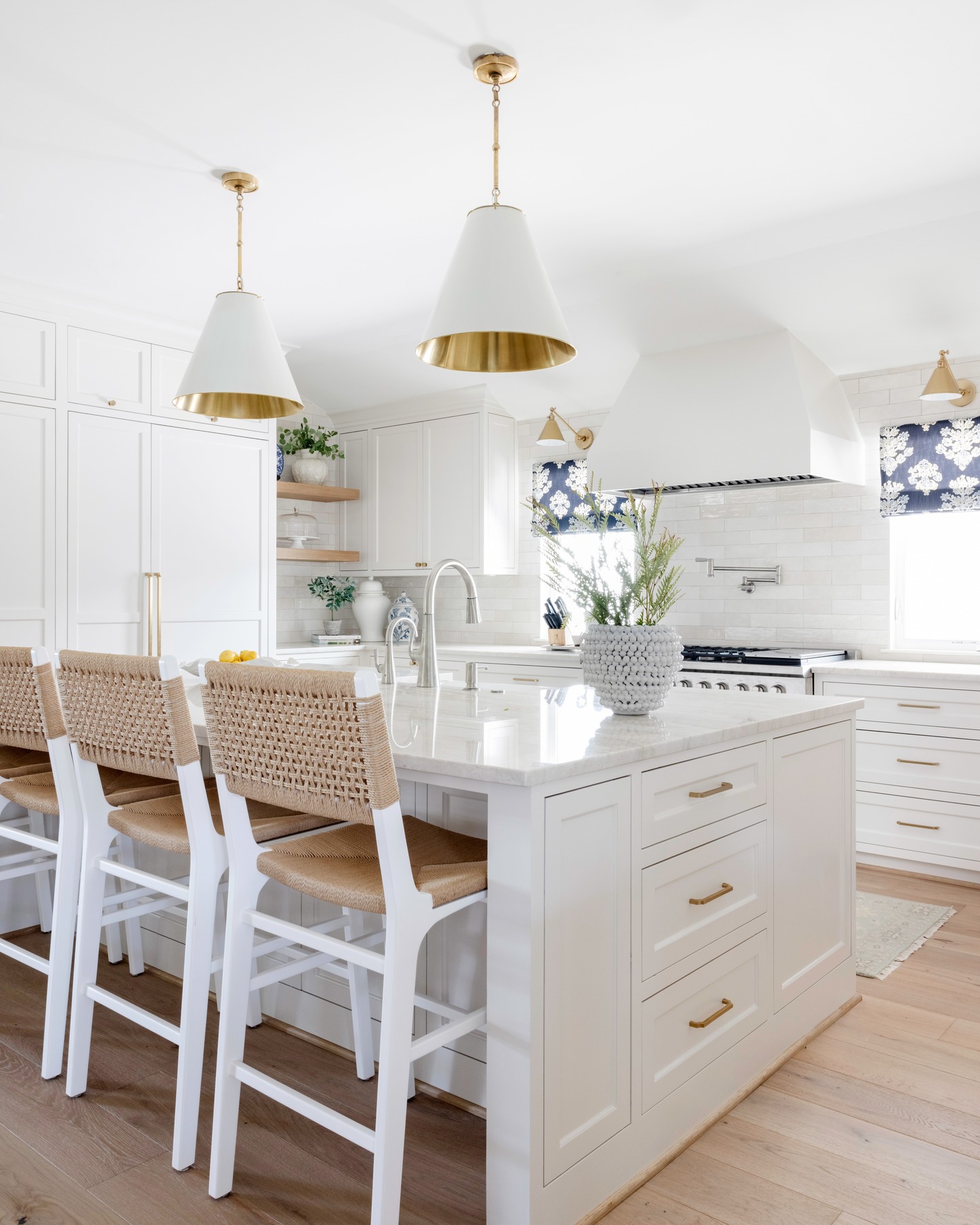 9. Glossy White Cabinets with Matte Black Hardware and a Hint Of Brass
