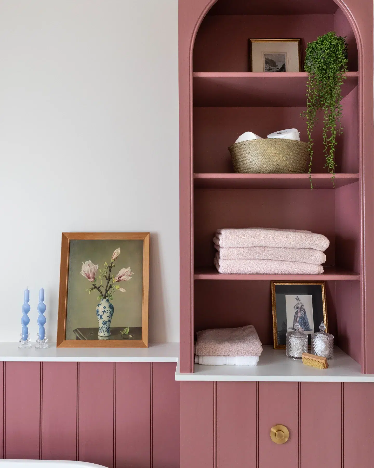 11. Under-sink Sliding Baskets with Coastal-themed Towels on a White Wooden Shelf