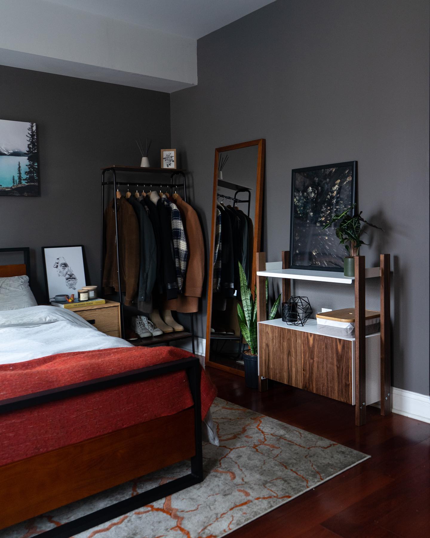 6. Midnight Blue Accent Wall with Industrial Pipe Shelving and Edison Bulbs