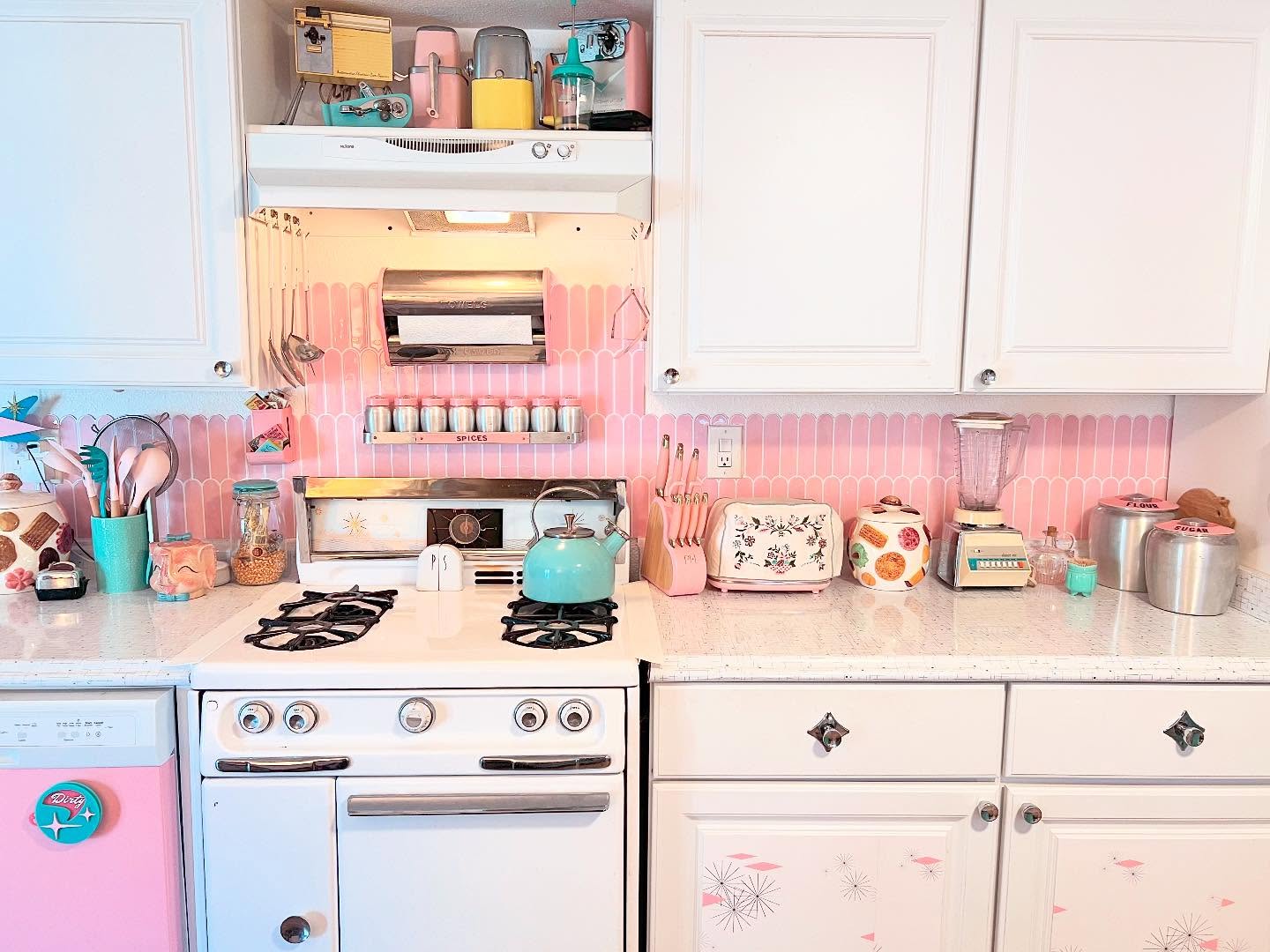 33. Vibrant Raspberry Cabinets with Mint Green Accents and Checkerboard Flooring