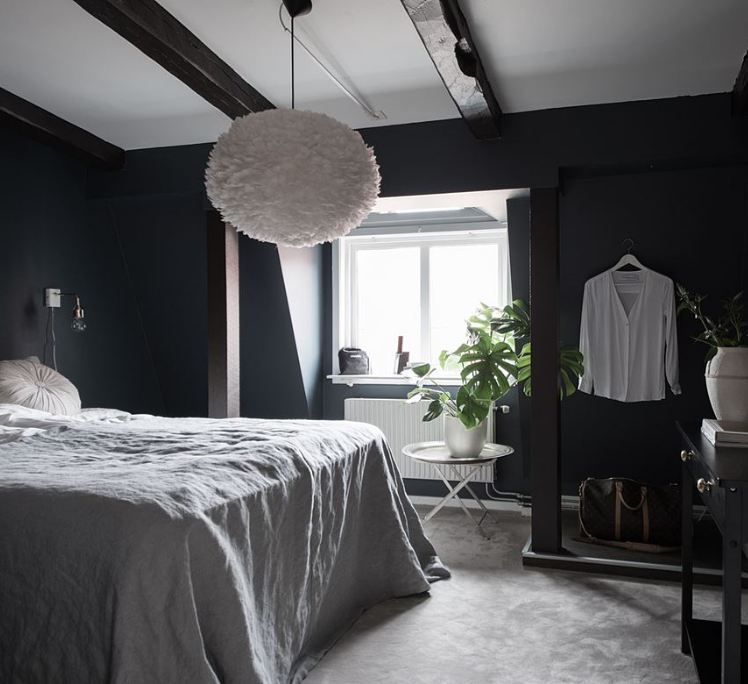 12. Midnight Velvet Canopy: a Black Bedroom with Sheer Drapes and Starry Accents