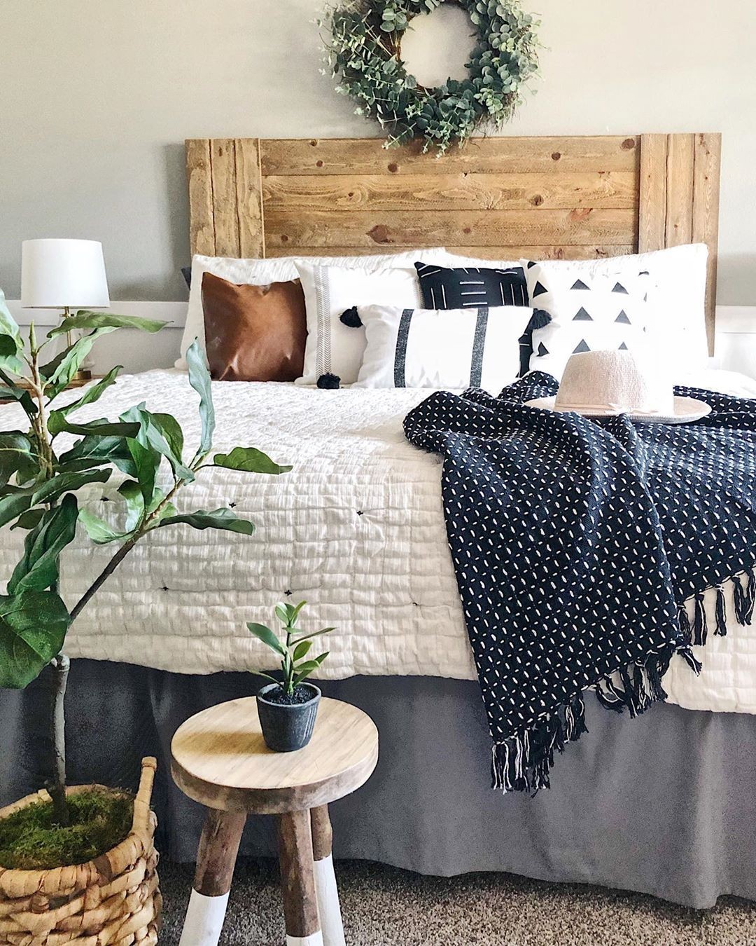 31. Handcrafted Barnwood Headboard with Vintage Lantern Accents