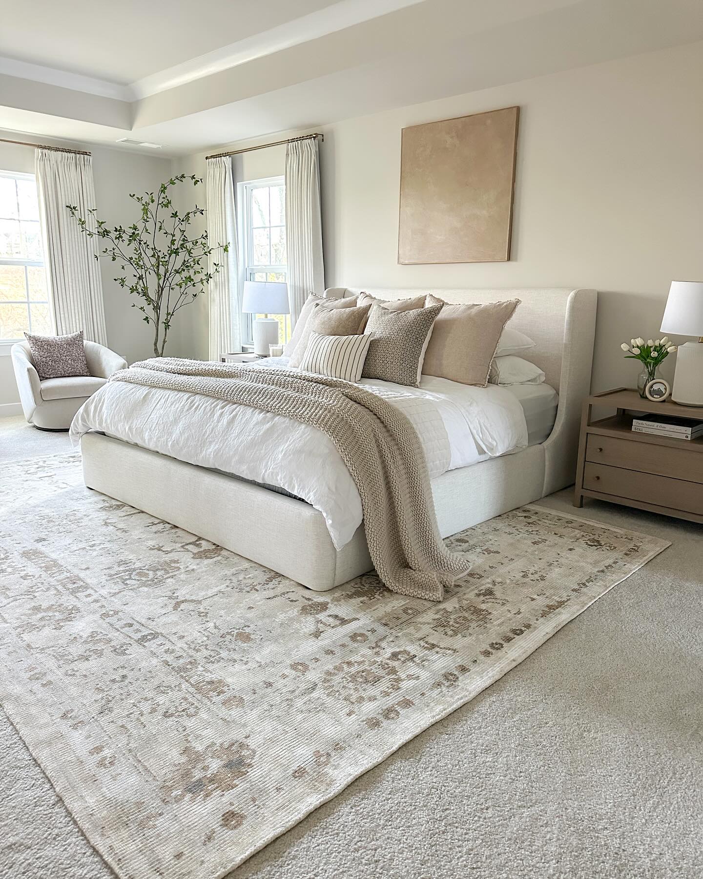 50. a Canopy Of Soft Taupe Drapes Over a Woven Rattan Bed Frame
