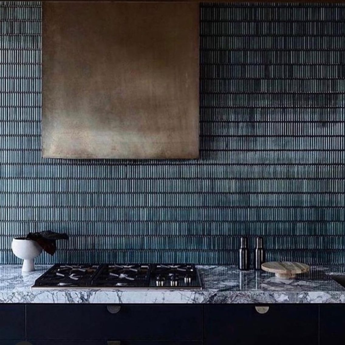 1. Glass River Mosaic with Cobalt Accents Flowing Through White Tile Backsplash