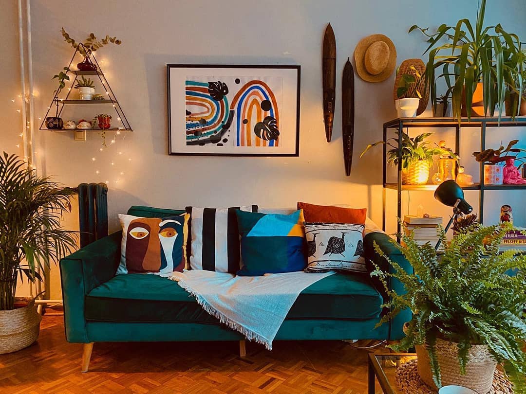 27. the Crimson Velvet Sofa with Geometric Wall Art In a Sunlit Corner