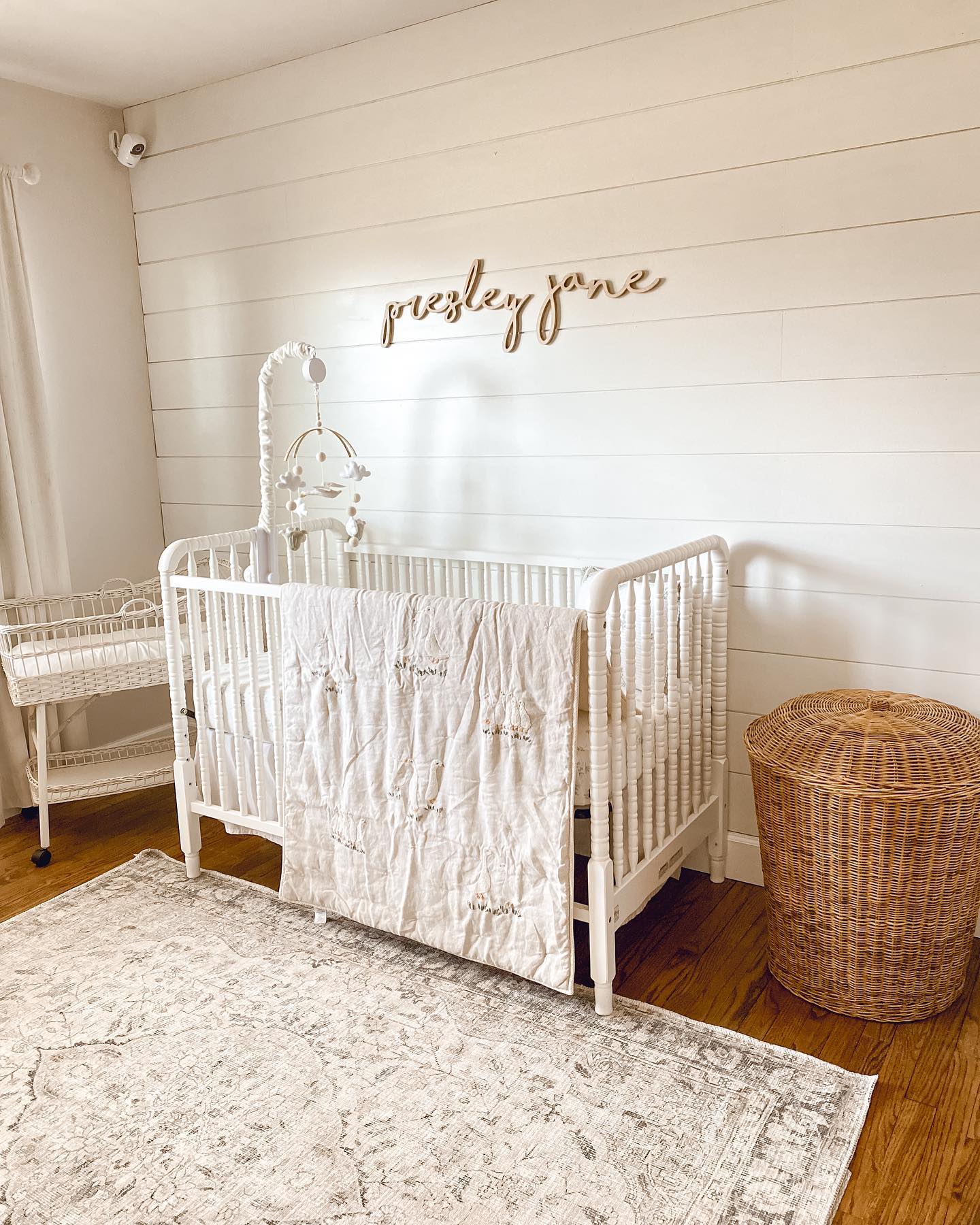 29. Whimsical Willow Canopy Over a Vintage Crib with Starry Wall Decals