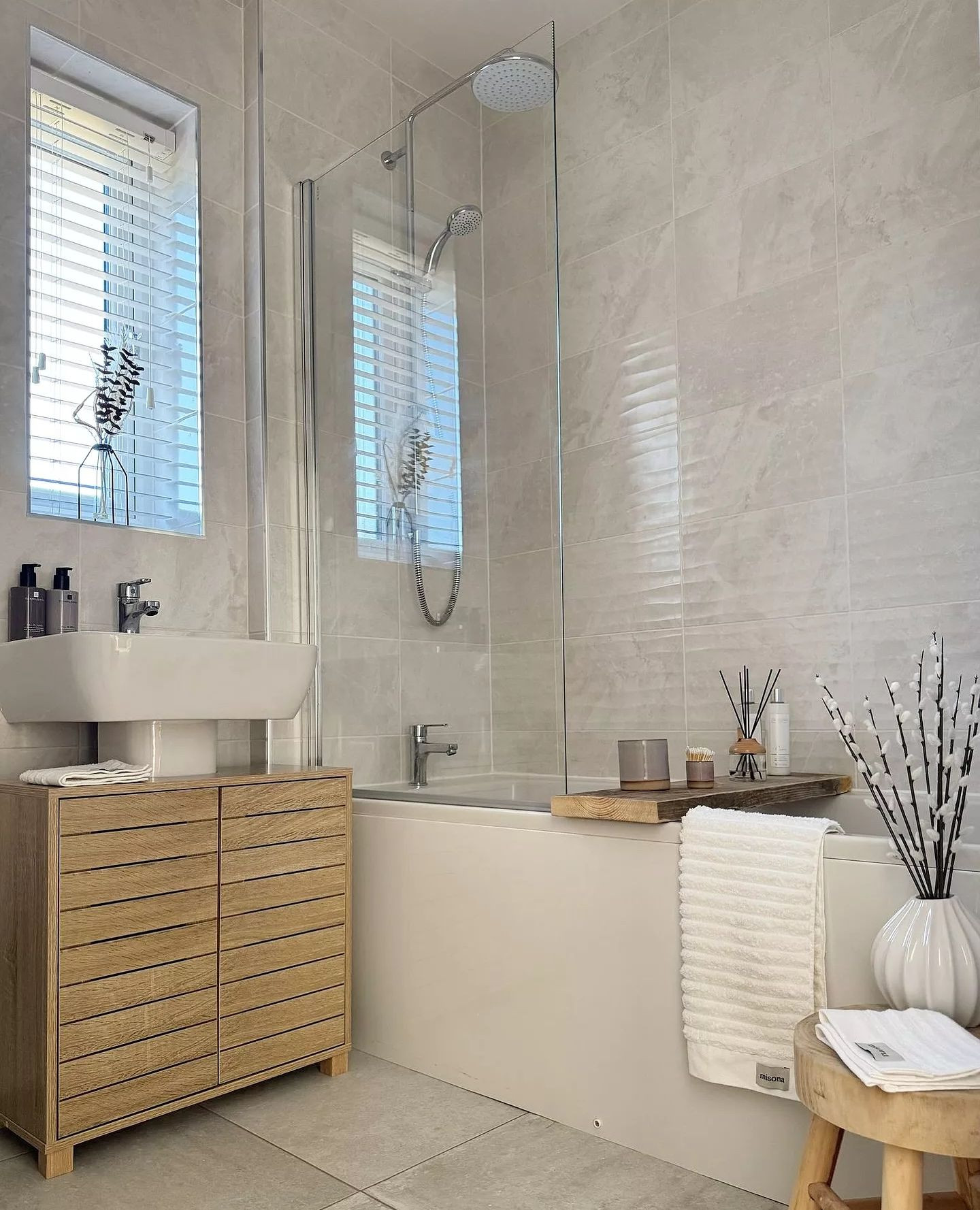 20. Floating Shelf with Geometric Towel Display and Gold Accents