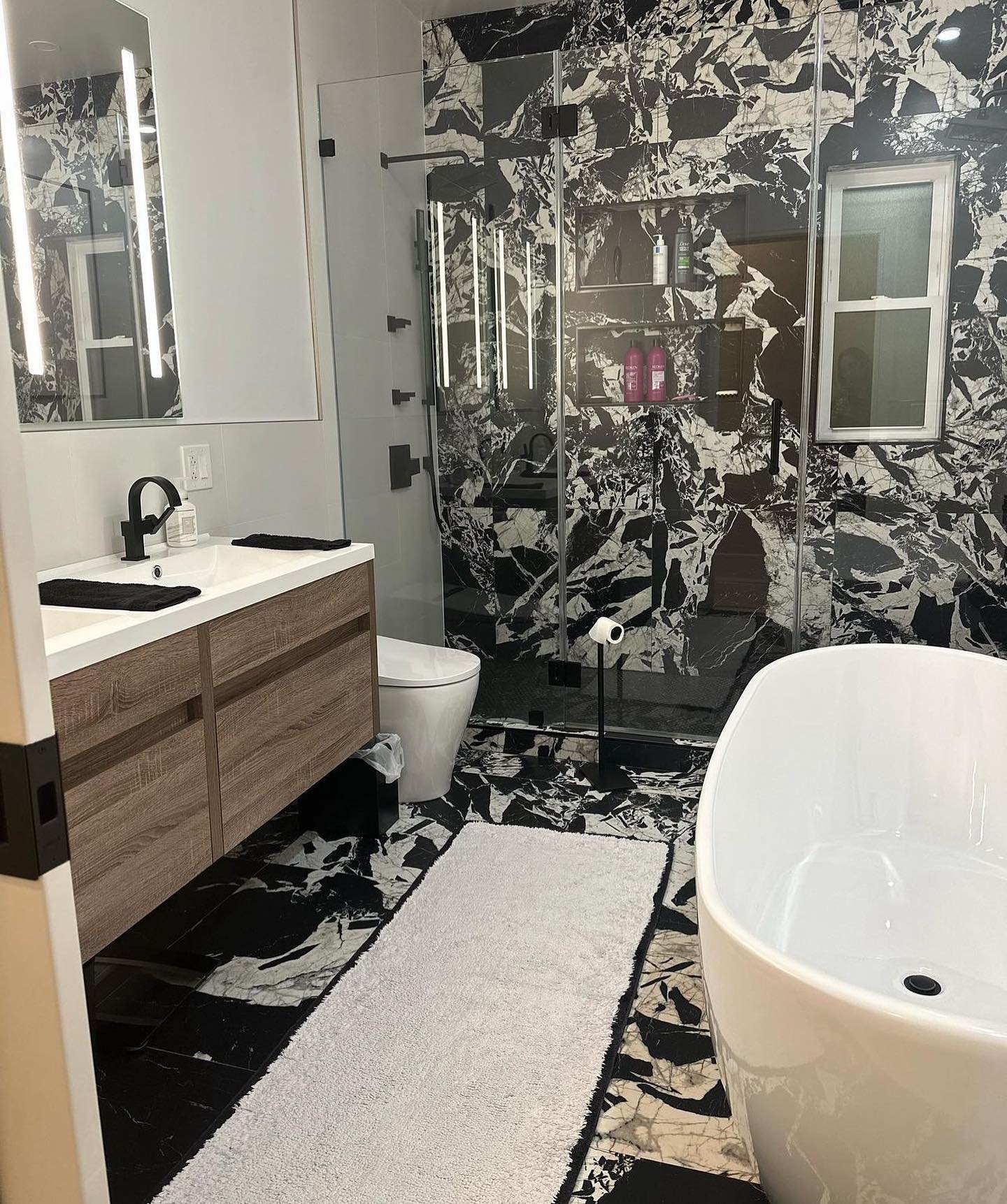 12. Midnight Mosaic: a Monochrome Masterpiece with Intricate Tile Work and Sculpted Sink
